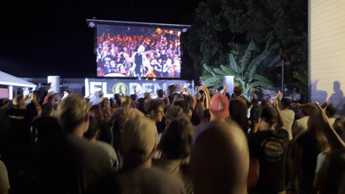 Outdoor concert stage at golden hour with the TV1 LED wall glowing over Haleʻiwa