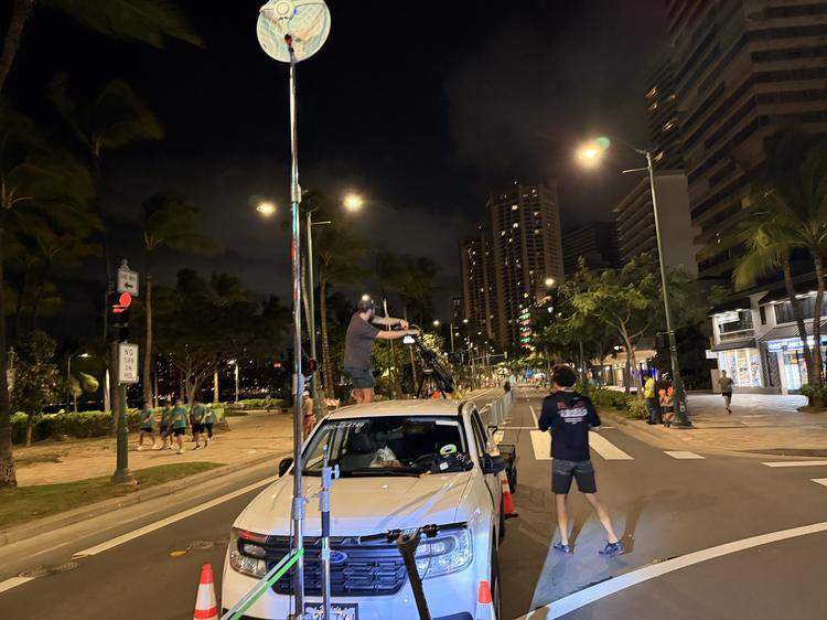 60 GHz wireless dish and camera jib rig transporting a live feed at night in Waikīkī